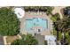 Aerial view of a sparkling swimming pool with sunbathers and plenty of lounge chairs at 1010 Nicholwood Dr # 301, Raleigh, NC 27605