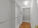 Walk-in closet features custom shelving and hanging space for optimal organization and storage solutions at 1010 Nicholwood Dr # 301, Raleigh, NC 27605