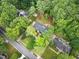 An aerial view of a charming home surrounded by trees with a pool and well maintained landscaping at 105 Bathgate Ln, Cary, NC 27513