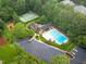 Aerial view of community clubhouse with a tennis court and a pool at 105 Bathgate Ln, Cary, NC 27513