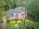 An aerial view of a spacious brick home with a landscaped yard featuring vibrant, mature trees at 105 Bathgate Ln, Cary, NC 27513