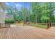 Spacious wooden deck overlooks a beautifully landscaped backyard, creating a serene outdoor retreat at 105 Bathgate Ln, Cary, NC 27513