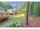 Lush backyard with an expansive lawn, mature trees, and a charming wooden deck for outdoor enjoyment at 105 Bathgate Ln, Cary, NC 27513
