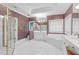 Bright bathroom with all-white fixtures, shower, and large bathtub at 105 Bathgate Ln, Cary, NC 27513