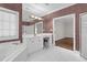 Well-lit bathroom with tub, white cabinets and vanity, and tiled floor at 105 Bathgate Ln, Cary, NC 27513