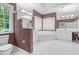 Bright bathroom features a shower, toilet, and dual sinks with white cabinets and tiled floors at 105 Bathgate Ln, Cary, NC 27513