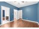 Bedroom with hardwood floors and doors to bathroom and walk-in closet at 105 Bathgate Ln, Cary, NC 27513