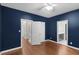 Bedroom with hardwood floors, doors to closet and bathroom, and navy walls at 105 Bathgate Ln, Cary, NC 27513