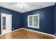 Bedroom with hardwood floors, blue walls, and large window for natural light at 105 Bathgate Ln, Cary, NC 27513