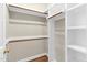 Walk in closet with shelving and wood flooring at 105 Bathgate Ln, Cary, NC 27513