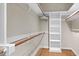 Walk-in closet with hardwood floors, built in shelving and wood closet rods at 105 Bathgate Ln, Cary, NC 27513
