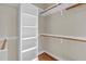 Walk-in closet features built in shelving and hardwood floors at 105 Bathgate Ln, Cary, NC 27513