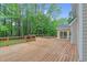 Expansive wooden deck with in-ground pool offers ample space for outdoor entertaining and relaxation at 105 Bathgate Ln, Cary, NC 27513