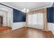 Elegant dining room with hardwood floors, crown molding, and designer window treatments at 105 Bathgate Ln, Cary, NC 27513