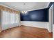 Elegant dining room featuring hardwood floors, soft lighting, and classic curtains at 105 Bathgate Ln, Cary, NC 27513