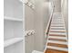 Entryway with coat hooks, built in shelves, and stairs with wood and white trim at 105 Bathgate Ln, Cary, NC 27513