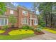 Charming two-story brick home with well-manicured landscaping, mature trees and a inviting porch at 105 Bathgate Ln, Cary, NC 27513