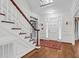 Bright foyer with hardwood floors, staircase, and ample natural light from front door at 105 Bathgate Ln, Cary, NC 27513