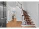 Welcoming foyer with hardwood floors, staircase with patterned runner, and decorative trim at 105 Bathgate Ln, Cary, NC 27513