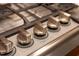 Close up of Thermador gas cooktop with stainless steel knobs and accents at 105 Bathgate Ln, Cary, NC 27513