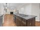 Kitchen island features wood cabinets, granite counters, and stainless steel gas cooktop at 105 Bathgate Ln, Cary, NC 27513