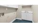 Laundry room with utility sink, white cabinets, and blue tiled floor at 105 Bathgate Ln, Cary, NC 27513