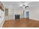 Spacious living room with a fireplace, built-in shelving, and hardwood floors at 105 Bathgate Ln, Cary, NC 27513