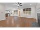 Open-concept living area with hardwood flooring, natural light, and a glimpse of the kitchen at 105 Bathgate Ln, Cary, NC 27513