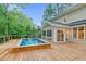 An in-ground pool is surrounded by a wooden deck and a cozy screened-in porch, perfect for outdoor living at 105 Bathgate Ln, Cary, NC 27513
