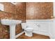 Stylish powder room featuring decorative wallpaper, pedestal sink, and modern fixtures at 105 Bathgate Ln, Cary, NC 27513