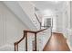 Second floor landing with wood floors, white railing, and trim at 105 Bathgate Ln, Cary, NC 27513