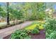 Landscaped yard featuring mature trees and a stone bench, creating a serene and inviting atmosphere at 105 Bathgate Ln, Cary, NC 27513