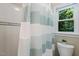 Bathroom featuring a shower/tub combo and a window providing natural light and a view of the surrounding trees at 105 Windfall Ct, Cary, NC 27518