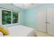 Bedroom with closet and large window providing lots of natural light with a view of trees and greenery at 105 Windfall Ct, Cary, NC 27518