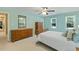 A bright and airy bedroom features plenty of natural light and wooden furniture for ample storage at 105 Windfall Ct, Cary, NC 27518