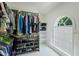 Spacious walk-in closet features custom shelving and an abundance of hanging space by a window for natural light at 105 Windfall Ct, Cary, NC 27518
