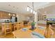 Open dining area with wood floors, a large kitchen island and view of the living room at 105 Windfall Ct, Cary, NC 27518