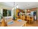 Dining area with seating for four, view to the kitchen and access to outside at 105 Windfall Ct, Cary, NC 27518