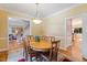 Traditional dining area featuring a round wood table, seating for six, and access to other rooms at 105 Windfall Ct, Cary, NC 27518
