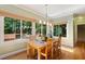 Sunlit dining area with wood floors, large windows, and a view of the deck at 105 Windfall Ct, Cary, NC 27518