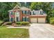 Traditional brick home with two-car garage, manicured lawn, and front brick walkway at 105 Windfall Ct, Cary, NC 27518