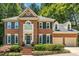Stately brick home with a two car garage and mature landscaping at 105 Windfall Ct, Cary, NC 27518
