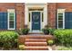Close up of the front door, brick steps, and detailed landscaping at 105 Windfall Ct, Cary, NC 27518
