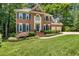 Well manicured front lawn with brick home, traditional windows, and two-car garage at 105 Windfall Ct, Cary, NC 27518