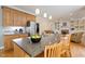 Open concept kitchen with island seating and stainless steel refrigerator at 105 Windfall Ct, Cary, NC 27518