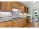 Modern kitchen with light wood cabinetry, backsplash, and hardwood floors at 105 Windfall Ct, Cary, NC 27518