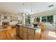 Open kitchen flows to living space with hardwood flooring and natural lighting at 105 Windfall Ct, Cary, NC 27518