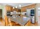 Gourmet kitchen with granite counters, stainless steel appliances, and center island at 105 Windfall Ct, Cary, NC 27518