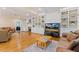 Living room with a fireplace, built-in shelving, and hardwood flooring at 105 Windfall Ct, Cary, NC 27518