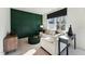 Living room area with stylish green accent wall, comfortable seating, and natural light at 10508 Pleasant Branch Dr # 37, Raleigh, NC 27614